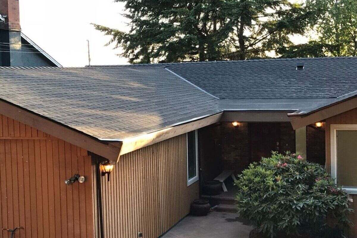 Residential roof replacement in Vancouver featuring gray asphalt shingles, neat roof edges and a covered front entry