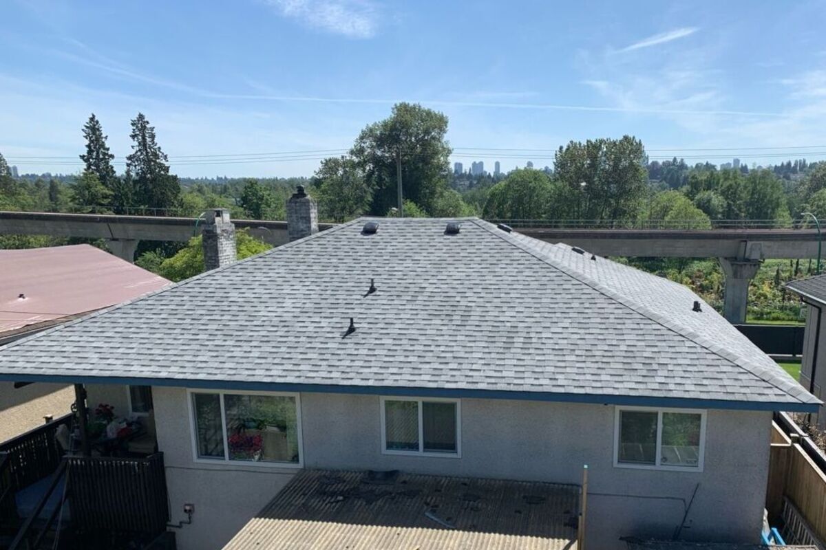 Gray asphalt shingles on a private home roof after repair
