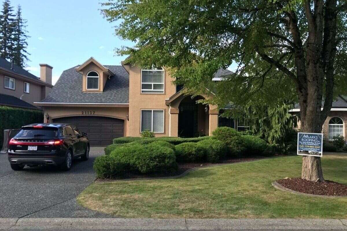 Completed residential roof replacement in Vancouver with dark asphalt shingles and a clean front exterior view