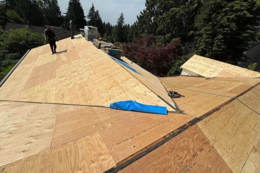 Marks Roofing is installing new plywood roof decking on a large residential roof during a full roof replacement project.