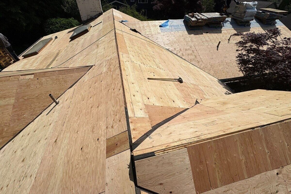 Marks Roofing is installing new plywood roof decking on a residential roof during a full roof replacement project.