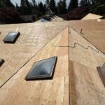 Marks Roofing is installing new plywood roof decking around skylights during a residential roof replacement project.