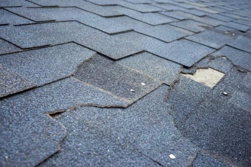damaged asphalt roofing shingles