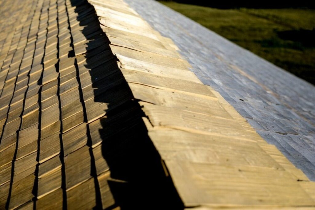 Close-up of cedar shake roofing and ridge caps on a sloped roof